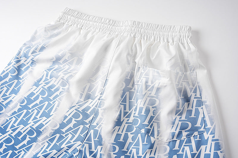 AMIRI logo-print gradient silk shorts